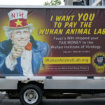 A van with an anti-NIH billboard featuring Anthony Fauci.