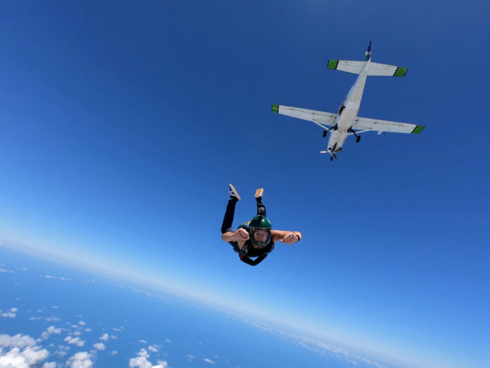 shutterstock2262093471 Skydiver jumping from airplane in clear blue sky