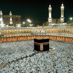 Aerial view of the Kaaba surrounded by a large crowd of worshippers at night