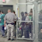 DEMOCRATS SCRAMBLE Over Outrageous Prison Pledge People detained behind fencing in a detention center.