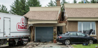 Truck crashed into house with damaged garage and car