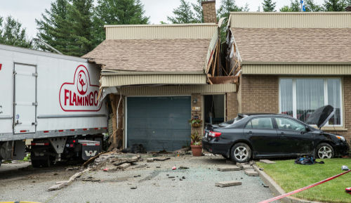 Truck crashed into house with damaged garage and car