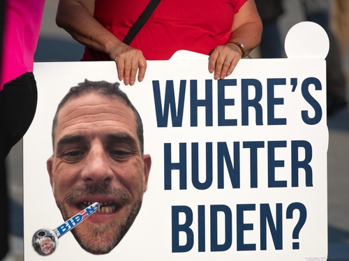 Milwaukee,,Wisconsin,,Usa,-,August,23,,2023:,A,Supporter,Of A protestor holding a sign with a large image of a mans face and the text WHERES HUNTER BIDEN?