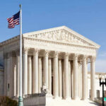 United States Supreme Court building with American flag.