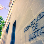 Faith Clash Explodes — DOJ Enters Department of Justice building with American flag.