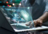 Silent AI Hacks Multiply Fast Person using laptop with futuristic data and analytics interface