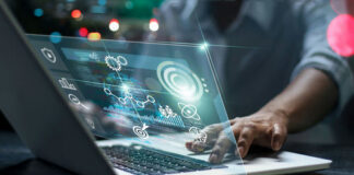 Person using laptop with futuristic data and analytics interface