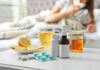 Trainee Death Under Review—Panic Grows Medicines, honey, and lemon on table beside sick person.