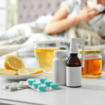 Trainee Death Under Review—Panic Grows Medicines, honey, and lemon on table beside sick person.