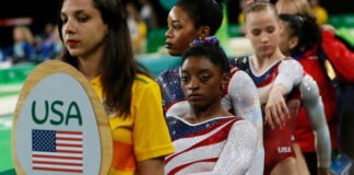 USA gymnasts waiting in line at an event.