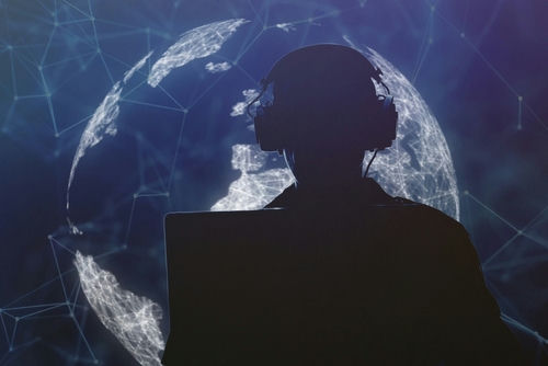 shutterstock_2257702203 Silhouette of person with headphones in front of globe.