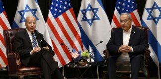 Two political leaders seated with flags in the background