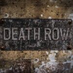 Aged metal sign reading Death Row on a weathered wall