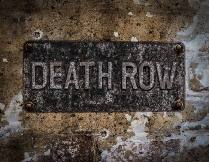 Aged metal sign reading Death Row on a weathered wall