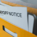 Did Meta’s AI System Fire Workers for Taking Medical Leave? Folder with layoff notice in yellow box.