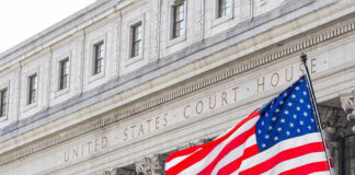 United States courthouse with American flag waving.