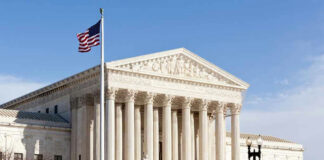 United States Supreme Court building with American flag.