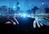 Human hand and robotic hand reaching toward each other with glowing touch