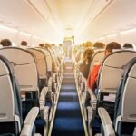 Seat Refusal Explodes Into Violence airplane cabin with passengers seated in economy class