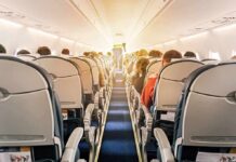 Seat Refusal Explodes Into Violence airplane cabin with passengers seated in economy class