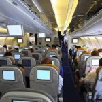 Mid-Flight Meltdown Sparks Germany Uproar Interior view of an airplane with passengers seated and using in-flight entertainment screens