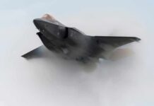 Stealth fighter jet piercing a vapor cloud