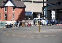 Homeless encampment with tents along a city street