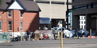 Homeless encampment with tents along a city street