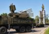 Russia-Iran Intel Link Puts U.S. In Crosshairs military air defense vehicles on a road