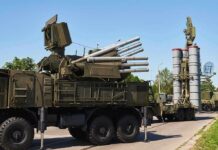 military air defense vehicles on a road