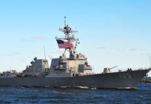 The Ceasefire That Lasted a Month — Now Both Sides Are Attacking Again naval destroyer with flags sailing on open water