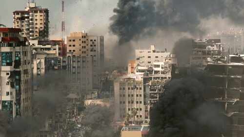 Rimal,Neighborhood,Destroyed,In,The,War,gaza,,Aerial,View,,Drone,View A cityscape showing damaged buildings and thick smoke rising from the ground