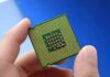 Price Shock Hits AI Optics Close-up of a computer CPU held between fingers
