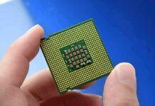 Price Shock Hits AI Optics Close-up of a computer CPU held between fingers