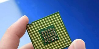 Close-up of a computer CPU held between fingers