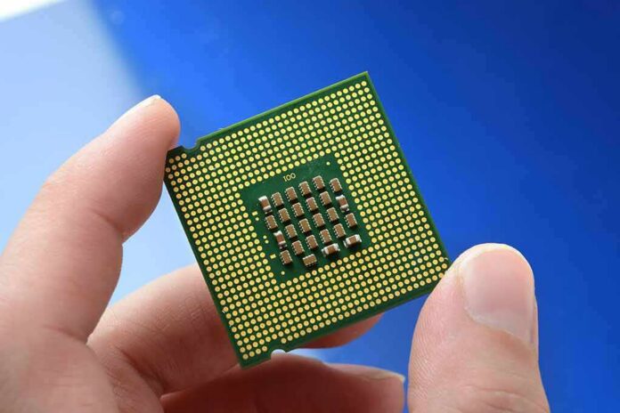 Close-up of a computer CPU held between fingers