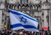 Israeli flag at a crowded outdoor event.