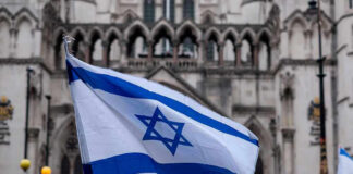 Israeli flag at a crowded outdoor event.