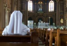Holy See Shake-Up: Feminist Voices Rise Person in white habit seated in a church pew facing the altar