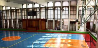 Indoor basketball court with blue floor and orange key areas