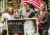 Cafe Showdown Ignites Free Speech Fight Group of people holding a pro-life sign at an outdoor rally