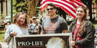 Group of people holding a pro-life sign at an outdoor rally