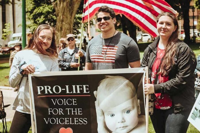 shutterstock_1427765420 Group of people holding a pro-life sign at an outdoor rally
