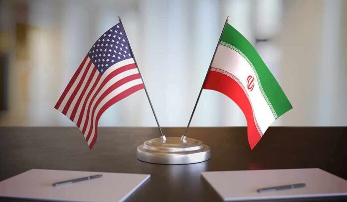shutterstock_1609200817 United States and Iran desk flags on a stand