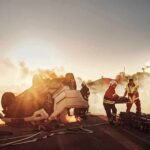 Emergency responders at overturned car crash scene