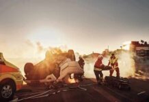 Emergency responders at overturned car crash scene