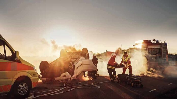 Emergency responders at overturned car crash scene