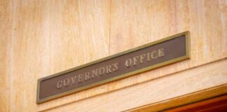 Governor's Office sign above a wooden doorway