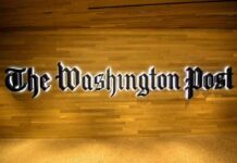 The Washington Post logo on a wooden wall