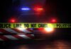 Nightlife Crowd Hit After Driver Flees Police Police car behind crime scene tape at night